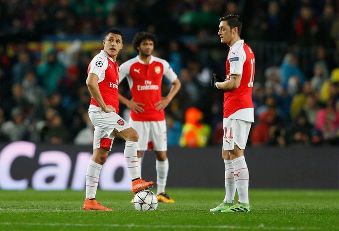 Arsenal's Alexis Sanchez and Mesut Ozil look dejected after Neymar scored the first goal for Barcelona