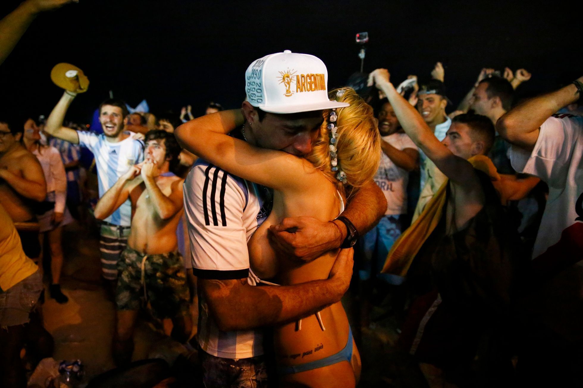 Argentina fans react after their team won the 2014 World Cup semi-final match against the Netherlands as they watched at Copacabana beach in Rio de Janeiro