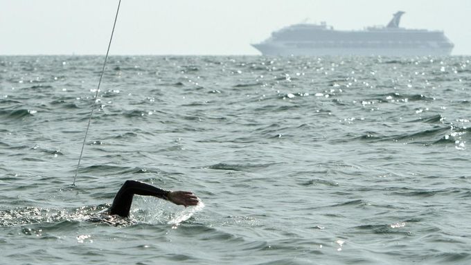 A cruise ship passes in the distance as Diana Nyad trains off Key West, Florida, August 13, 2012. Nyad, who turns 63 on August 22nd, plans to begin her fourth attempt to