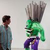 A man inspects a sculpture before the opening of a Jeff Koons retrospective at the Whitney Museum of American Art in New York
