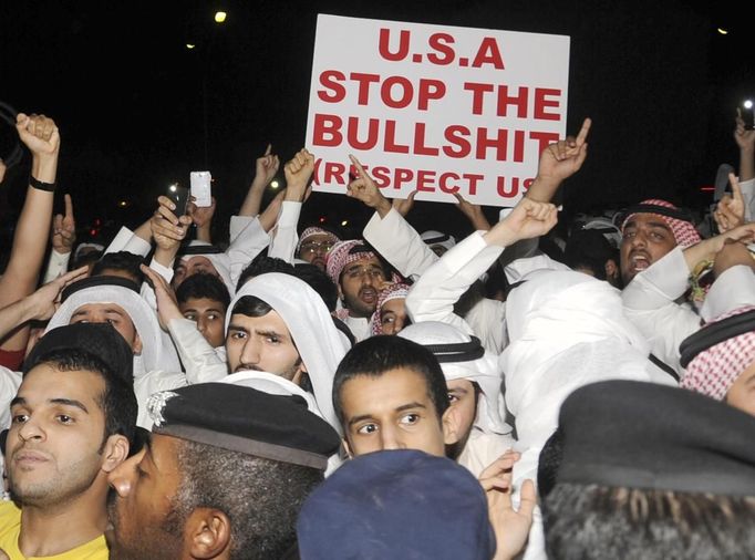 Protesters shout slogans outside the U.S. embassy in Bayan September 13, 2012. Demonstrations spread further on Thursday, with U.S. embassies again the targets of popular anger among Muslims questioning why the United States has failed to take action against the makers of a film they consider blasphemous to Islam. Around 200 demonstrators shouted slogans outside the U.S. embassy in Kuwait as riot police encircled the crowd of men protesting peacefully in their traditional Kuwaiti dress.