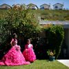 Mimi Pineda, whose parents are from El Salvador, stands outside her aunt's house with Maybelin Ramirez, before her quinceanera  in Santa Clarita, California