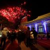 Buddhist believers watch as fireworks go off during a ceremony to celebrate the new year at Bongeun Buddhist temple in Seoul