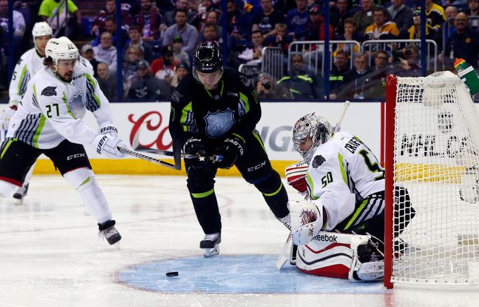 Jan 25, 2015; Columbus, OH, USA; Team Toews goaltender Corey Crawford (50) of the Chicago Blackhawks makes a save as Team Foligno forward Radim Vrbata (17) of the Vancouv