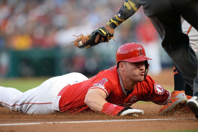 July 25, 2019; Anaheim, CA, USA; Los Angeles Angels center fielder Mike Trout (27) reaches third on a passed ball by Baltimore Orioles relief pitcher Jimmy Yacabonis (31)