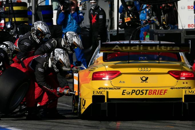 Mechanici Audi vyměňují pneumatiky u vozu Timo Scheidera.