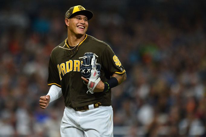 Jul 26, 2019; San Diego, CA, USA; San Diego Padres third baseman Manny Machado (13) laughs at the end of the top of the eighth inning after throwing out San Francisco Gia