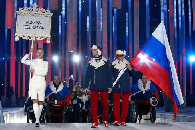 Russia's flag-bearer Valerii Redkozubov (R), leads his country's contingent during the opening ceremony of the 2014 Paralympic Winter Games in Sochi, March 7, 2014. REUTE