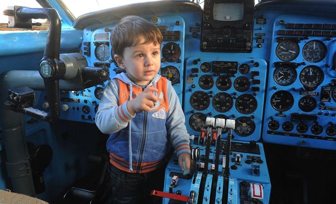 A picture taken on October 29, 2012, shows little boy playing inside a Soviet-era Yakovlev Yak-42 plane turned into their kindergarten in the Georgian city of Rustavi, some 25 km southeast of the capital Tbilisi. Local head teacher Gari Chapidze bought the old but fully functional Yak-42 from Georgian Airways and refurbished its interior with educational equipment, games and toys but left the cockpit instruments intact so they could be used as play tools.