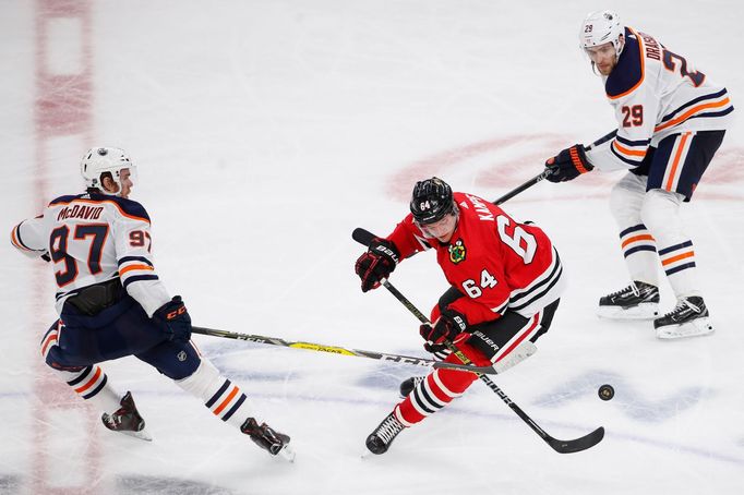 Oct 14, 2019; Chicago, IL, USA; Chicago Blackhawks center David Kämpf (64) battles for the puck against Edmonton Oilers center Connor McDavid (97) during the third period