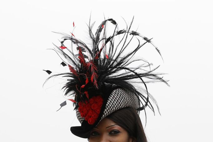 A woman poses in her hat on Ladies Day, the second day of racing at the Cheltenham Festival horse racing meet in Gloucestershire, western England March 14, 2012.