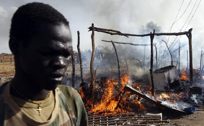 A SPLA soldier walks in a market destroyed in an air strike by the Sudanese air force in Rubkona near Bentiu