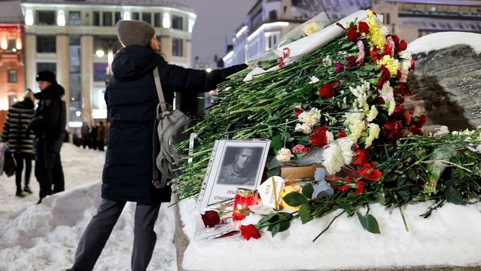 Žena pokládá květiny k památníku obětem politických represí po smrti ruského opozičního předáka Alexeje Navalného v Moskvě.