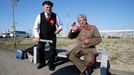 Men dressed as Soviet state founder Vladimir Lenin and Soviet leader Joseph Stalin pose for a picture in front of the paddock before the start of the Russian F1 Grand Pri