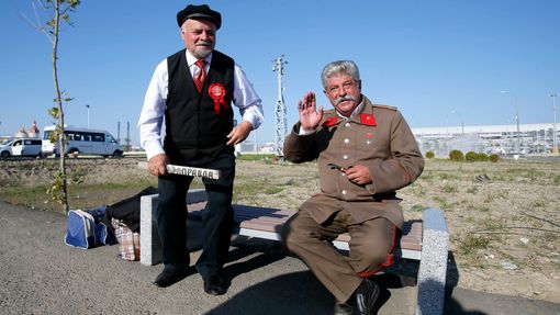 Men dressed as Soviet state founder Vladimir Lenin and Soviet leader Joseph Stalin pose for a picture in front of the paddock before the start of the Russian F1 Grand Pri