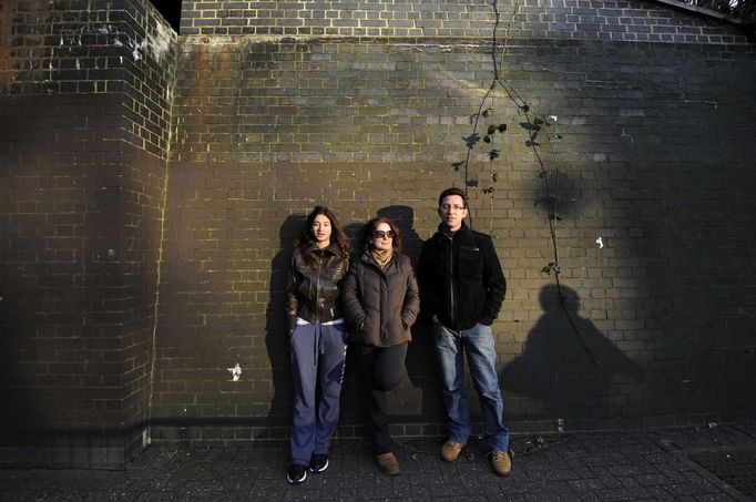 George Kapetanios poses for a photograph with his wife and daughter in Potters Bar, on the outskirts of London