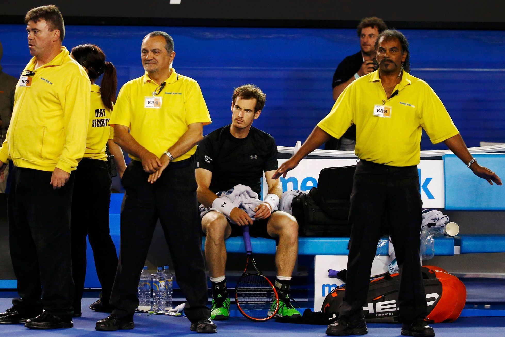 Security staff surround Murray of Britain as protesters are removed during his men's singles final match against Djokovic of Serbia at the Australian Open 2015 tennis tournament in Melbourne