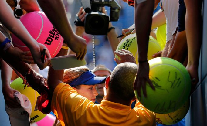 Canada's Eugenie Bouchard is mobbed for autographs after defeating Olga Govortsova of Belarus during their match at the 2014 U.S. Open tennis tournament in New York