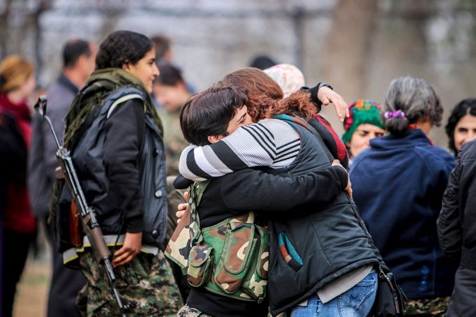 Female fighters of the Kurdish People's Protection Units (YPG) meet with their relatives at a military camp in Ras a-Ain, January 30, 2015.