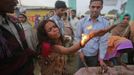 A devotee, believed to be possessed by evil spirits, cries as she performs a fire ritual on the sacred platform at Guru Deoji Maharaj temple during a ghost fair at Malajpur village in Betul district in the central Indian state of Madhya Pradesh January 27, 2013. People from across India come to this fair to be exorcised of �evil spirits�. They are usually brought by relatives and they are most often women. The exorcism involves running around the temple courtyard to make the 'ghost' weak then being beaten by a priest with a broom. Picture taken January 27, 2013. REUTERS/Danish Siddiqui (INDIA - Tags: SOCIETY RELIGION) ATTENTION EDITORS: PICTURE 9 OF 24 FOR PACKAGE 'INDIAN GHOSTBUSTERS' SEARCH 'INDIA GHOST' FOR ALL IMAGES Published: Úno. 5, 2013, 5:09 dop.