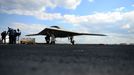 This May 13, 2013 US Navy handout image shows Northrop Grumman personnel conducting pre-operational tests on an X-47B Unmanned Combat Air System (UCAS) demonstrator on the flight deck of the aircraft carrier USS George H.W. Bush (CVN 77) during operations in the Atlantic Ocean. George H.W. Bush is scheduled to be the first aircraft carrier to catapult launch an unmanned aircraft from its flight deck.