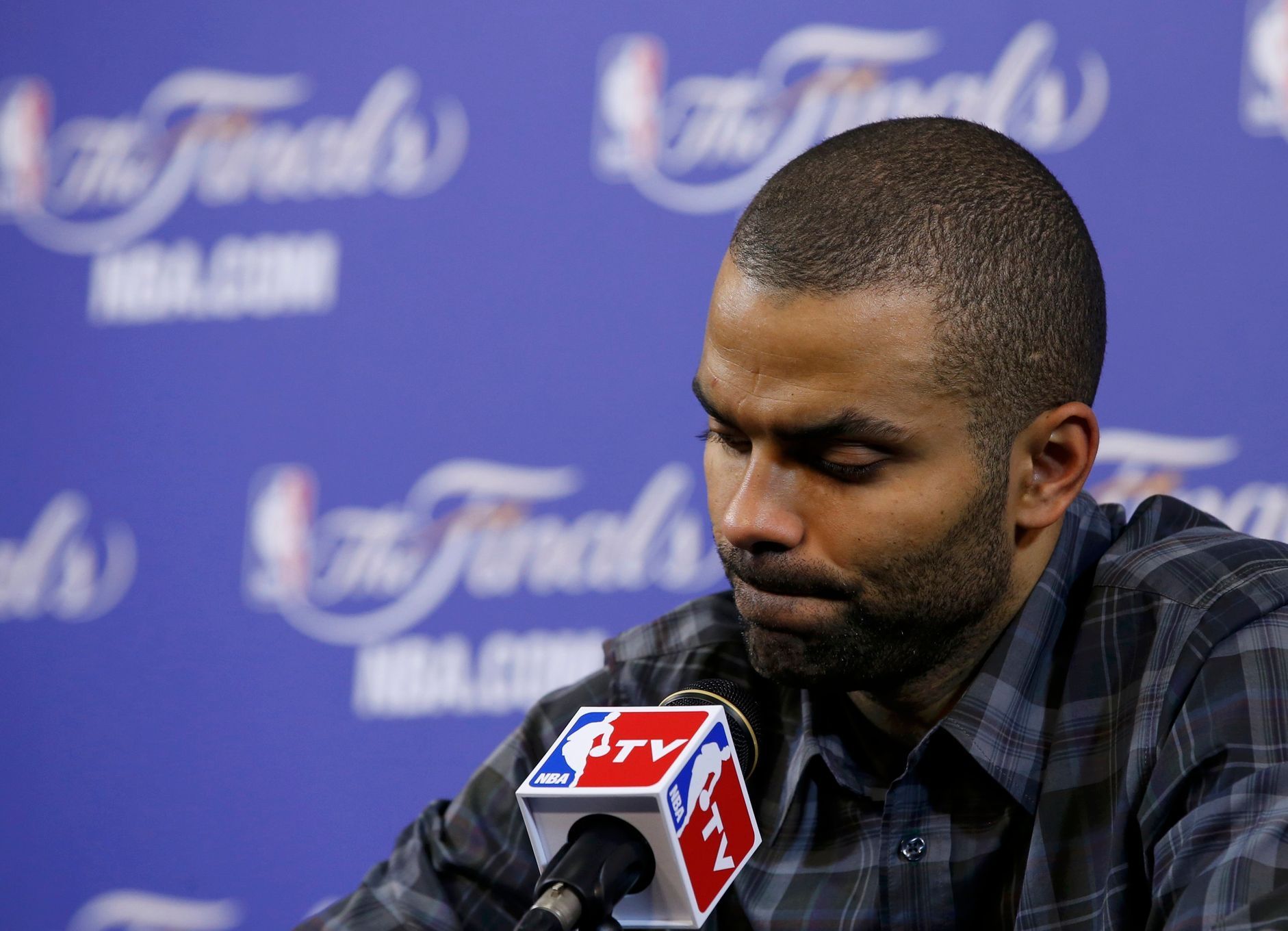 San Antonio Spurs' Tony Parker reacts as he speaks to the me