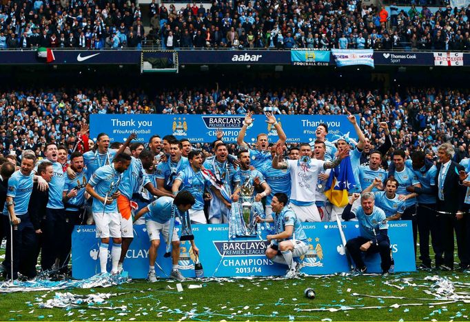 Manchester City's team celebrate after winning the English Premier League following their soccer match against West Ham United at the Etihad Stadium in Manchester