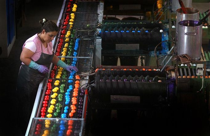 An employee controls the quality of colored eggs on March 30, 2012 at the egg dye factory in Thannhausen, southern Germany. During the Easter season, the plant produces daily around 180,000 hard-boiled and dyed eggs.