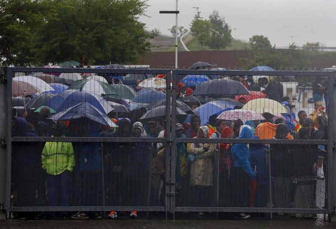 People arrive at First National Bank (FNB) Stadium, also known as Soccer City, ahead of a mass memorial for late former South African President Nelson Mandela in Johannesburg December 10, 2013.