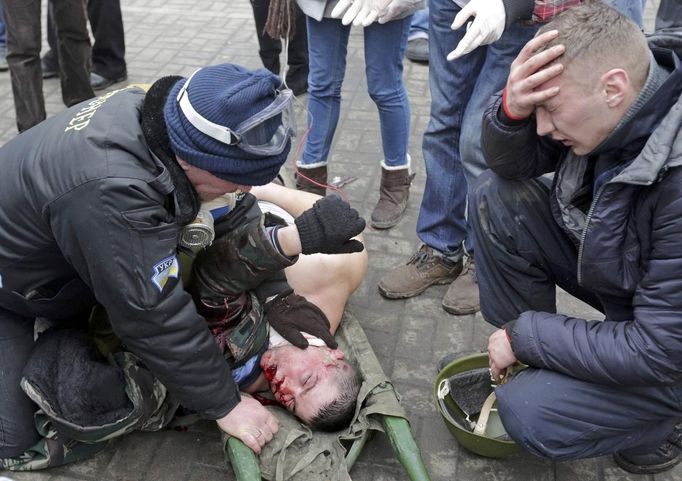 ATTENTION EDITORS - VISUAL COVERAGE OF SCENES OF INJURY OR DEATH - A wounded protester is attended before being rushed to a vehicle following violence in Independence Squ