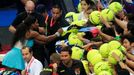 Serena Williams (L) of the Singapore Slammers signs autographs after winning their women's single match against Kirsten Flipkens of the Manila Mavericks during their wome