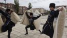 Members of a Chechen dance group pose for photographers at a government-organised event marking Chechen language day in the centre of the Chechen capital Grozny April 25, 2013. The naming of two Chechens, Dzhokhar and Tamerlan Tsarnaev, as suspects in the Boston Marathon bombings has put Chechnya - the former site of a bloody separatist insurgency - back on the world's front pages. Chechnya appears almost miraculously reborn. The streets have been rebuilt. Walls riddled with bullet holes are long gone. New high rise buildings soar into the sky. Spotless playgrounds are packed with children. A giant marble mosque glimmers in the night. Yet, scratch the surface and the miracle is less impressive than it seems. Behind closed doors, people speak of a warped and oppressive place, run by a Kremlin-imposed leader through fear. Picture taken April 25, 2013. REUTERS/Maxim Shemetov (RUSSIA - Tags: SOCIETY POLITICS RELIGION) ATTENTION EDITORS: PICTURE 11 OF 40 FOR PACKAGE 'INSIDE MODERN CHECHNYA'. SEARCH 'REBUILDING CHECHNYA' FOR ALL IMAGES Published: Kvě. 1, 2013, 7:39 dop.