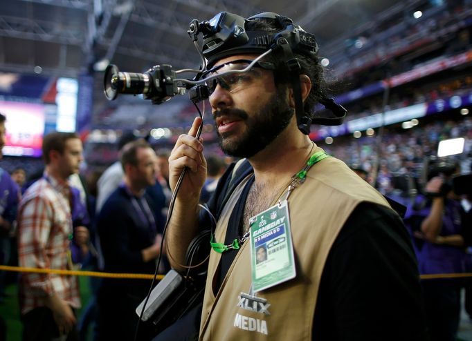 A member of the media wears a head-mounted camera to record events ahead of the start of the NFL Super Bowl XLIX football game between the Seattle Seahawks and the New En