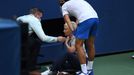 Sep 6, 2020; Flushing Meadows, New York, USA; Novak Djokovic of Serbia and a tournament official tend to a linesperson who was struck with a ball by Djokovic against Pabl