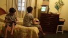 Gabriel Muniz (L), 11, plays a video game with his brother Mateus at home in Campos dos Goytacazes, 274 kilometres (170 miles) northeast of Rio de Janeiro August 22, 2012. Despite being born with malformation of his feet, fourth grader Gabriel puts in hours into soccer everyday in his neighbourhood. He aspires to be a professional soccer player just like his idol Argentina's Lionel Messi of Barcelona FC. Picture taken on August 22. REUTERS/Ricardo Moraes (BRAZIL - Tags: SPORT SOCCER SOCIETY HEALTH) Published: Srp. 24, 2012, 2:25 dop.