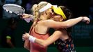 Caroline Wozniacki of Denmark is congratulated by Agnieszka Radwanska of Poland during their WTA Finals singles tennis match at the Singapore Indoor Stadium October 23, 2