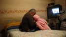 Agustin Gabarri (L) talks to his grandson Israel on the last night they slept at Gabarri's home before its demolition the following day at the Spanish gypsy settlement of Puerta de Hierro outside Madrid February 14, 2012. Fifty-four families have been living in Puerta de Hierro, on the banks of the Manzanares river for over 50 years. Since the summer of 2010, the community has been subject to evictions on the grounds that the dwellings are illegal. Families whose houses have been demolished, move in with relatives whose houses still remain while the debris keeps piling up around them as more demolitions take place. Picture taken February 14, 2012. REUTERS/Susana Vera (SPAIN - Tags: SOCIETY) ATTENTION EDITORS - PICTURE 13 OF 31 FOR PACKAGE 'GYPSY SITE DEMOLISHED' SEARCH 'GYPSY SITE' FOR ALL IMAGES Published: Lis. 5, 2012, 4:11 odp.