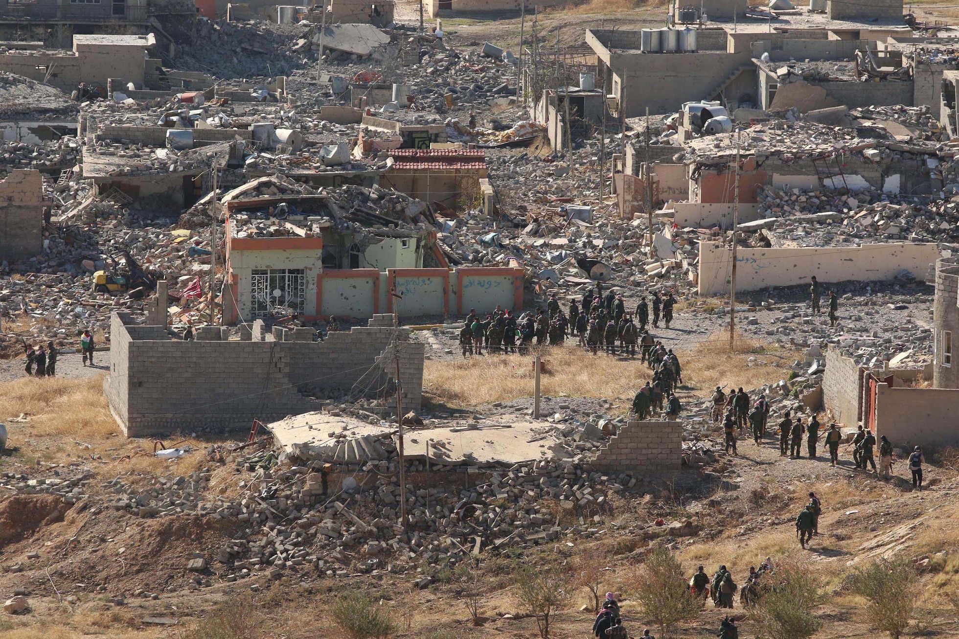 Members of the Kurdish peshmerga forces gather in the town of Sinjar