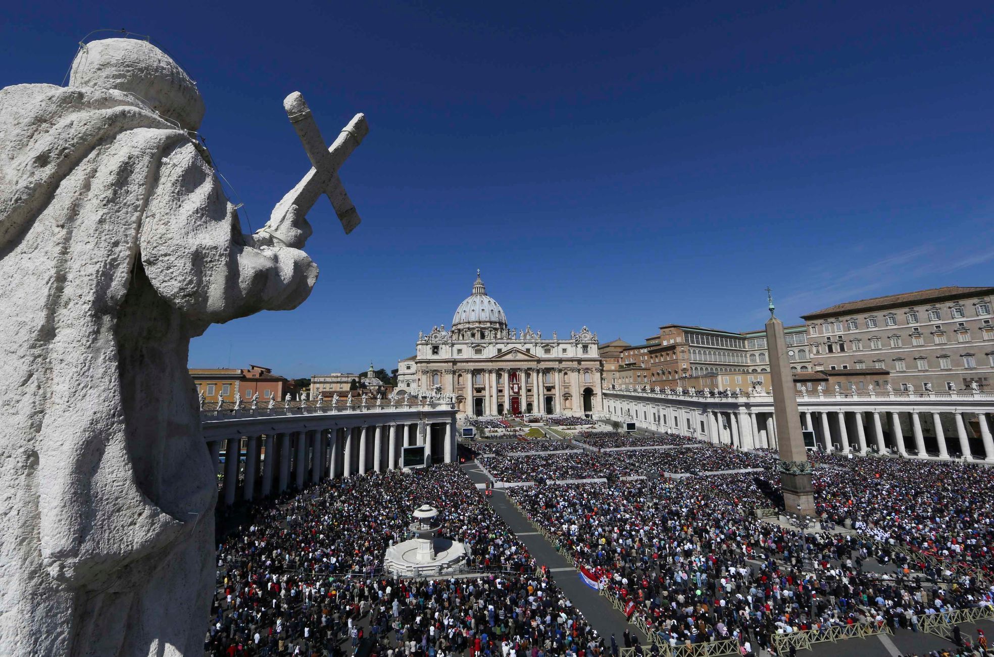 Faithful attend the Easter mass led by Pope Francis in Saint Peter's Square at the Vatican