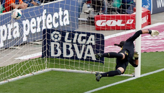 Barcelona's goalkeeper Pinto fails to make the save as Atletico Madrid's Godin scores past him during their Spanish First Division soccer match in Barcelona