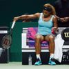Williams of the U.S. takes the plastic cover off a new racquet after smashing her first one during her WTA Finals singles semi-finals tennis match against Wozniacki of Denmark at the Singapore Indoor