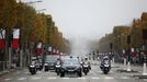 French President Emmanuel Macron arrives by car at a ceremony at the Arc de Triomphe, as part of the commemorations marking the 102nd anniversary of the 11 November 1918