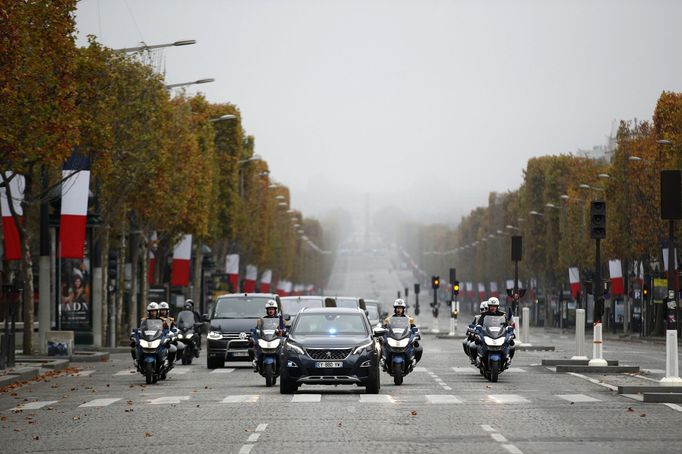 French President Emmanuel Macron arrives by car at a ceremony at the Arc de Triomphe, as part of the commemorations marking the 102nd anniversary of the 11 November 1918