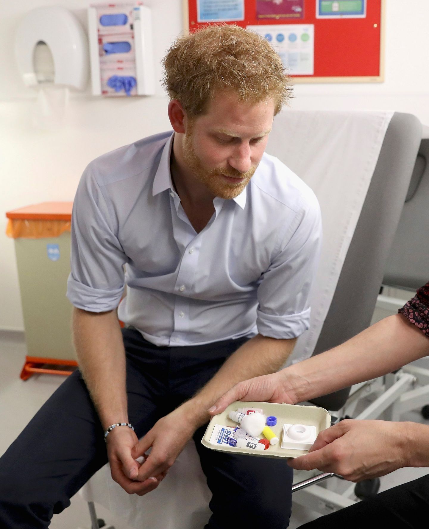 Prince Harry is shown the negative result of his HIV test by Specialist Psychotherapist Robert Palmer at the Burrell Street Sexual Health Clinic in London