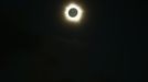 The moon passes in front of the sun during a full solar eclipse at Palm Grove near the northern Australian city of Cairns November 14, 2012. A rare full solar eclipse plunged north Queensland into darkness for two minutes early on Wednesday, delighting the thousands of people who had gathered on the Australian state's beaches. In Cairns, the main city in north Queensland and a gateway to the Great Barrier Reef, cloudy skies and occasional rain partly obscured the view, but elsewhere viewing conditions were more favourable. REUTERS/Tourism Queensland/Handout (AUSTRALIA - Tags: SOCIETY ENVIRONMENT) FOR EDITORIAL USE ONLY. NOT FOR SALE FOR MARKETING OR ADVERTISING CAMPAIGNS. THIS IMAGE HAS BEEN SUPPLIED BY A THIRD PARTY. IT IS DISTRIBUTED, EXACTLY AS RECEIVED BY REUTERS, AS A SERVICE TO CLIENTS Published: Lis. 14, 2012, 1:47 dop.