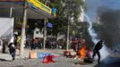 A demonstrator throws a tear gas bomb after military police shot at demonstrators during a protest against the 2014 World Cup, in Sao Paulo June 12, 2014. REUTERS/Nacho D