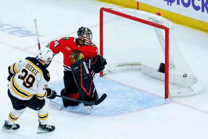 Dec 4, 2024; Chicago, Illinois, USA; Boston Bruins center Morgan Geekie (39) scores against Chicago Blackhawks goalie Petr Mrazek (34) during the third period at United C