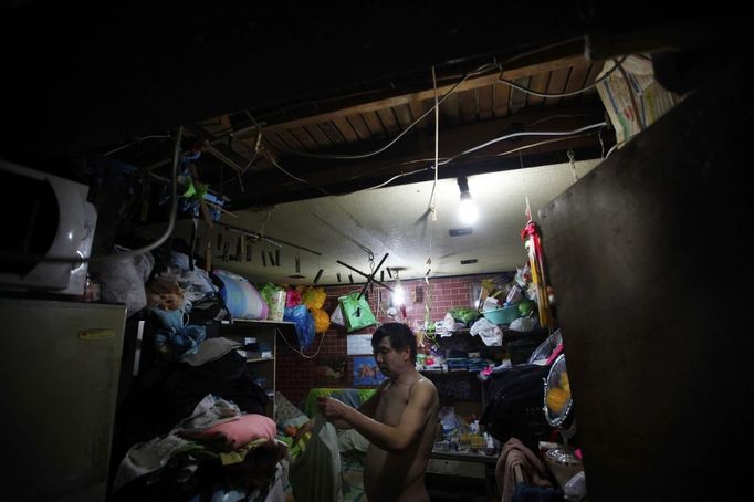 Xiao Cao, a 57-year-old gay man, gets dressed in his eight-square-metre apartment in downtown Shanghai April 8, 2012. China's gay community has long been on the edges of society but it is gradually becoming more accepted. Cao, who is an unemployed drag queen, is one whose life lifts the curtain on a less romanticised view of Chinese homosexuals. Living in an eight square metre apartment behind a public toilet and with a monthly income of 500 yuan ($79) from social insurance, he passes his days dancing in public and spending time with friends at gay clubs. Picture taken April 8, 2012. REUTERS/Aly Song (CHINA - Tags: SOCIETY) CHINA OUT. NO COMMERCIAL OR EDITORIAL SALES IN CHINA. ATTENTION EDITORS PICTURE 04 OF 28 OF PACKAGE 'GAY AND OUT IN CHINA' TO FIND ALL IMAGES SEARCH 'GAY OUT CHINA' Published: Čer. 1, 2012, 12:34 dop.