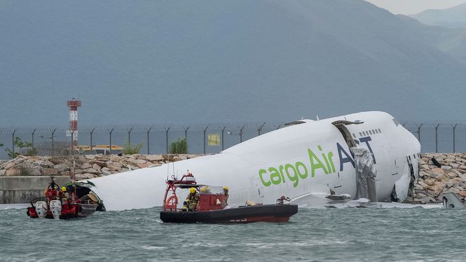 Responders on boats float around the cargo aircraft that skidded off a Hong Kong runway on Monday, Oct. 20, 2025. (AP Photo/Chan Long Hei)