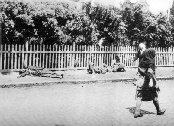 Žena prochází kolem lidí umírajících hlady během Rusy vyvolaného hladomoru na Ukrajině, 1932 až 1933.